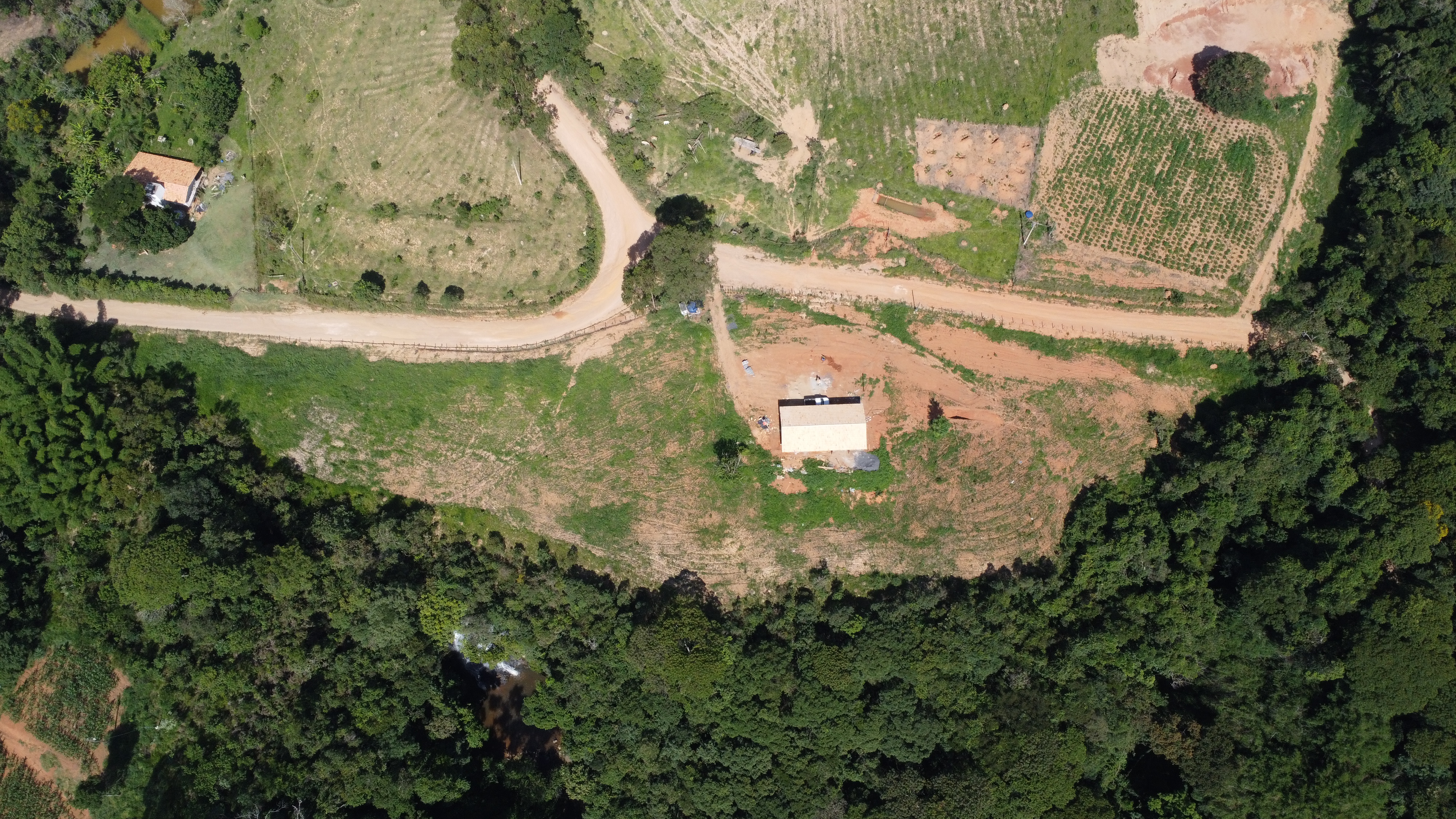 Aerial view of the property — house, road, cleared land